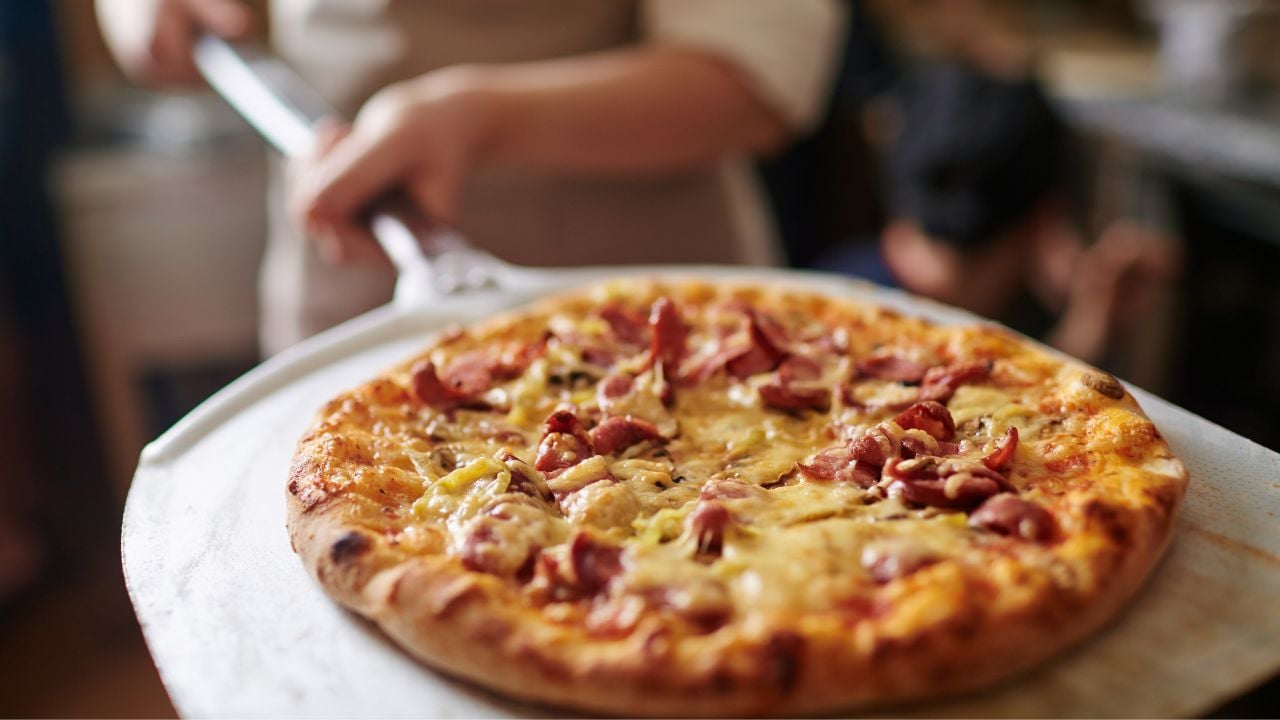 Pizza coming out of the oven.