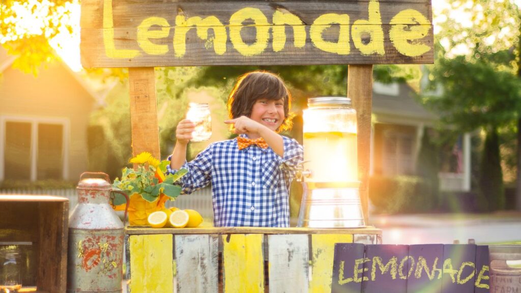 Kid selling lemonade.