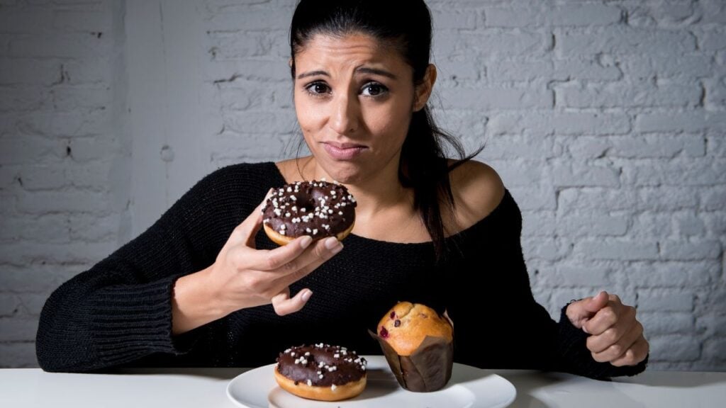 Woman eating donuts.