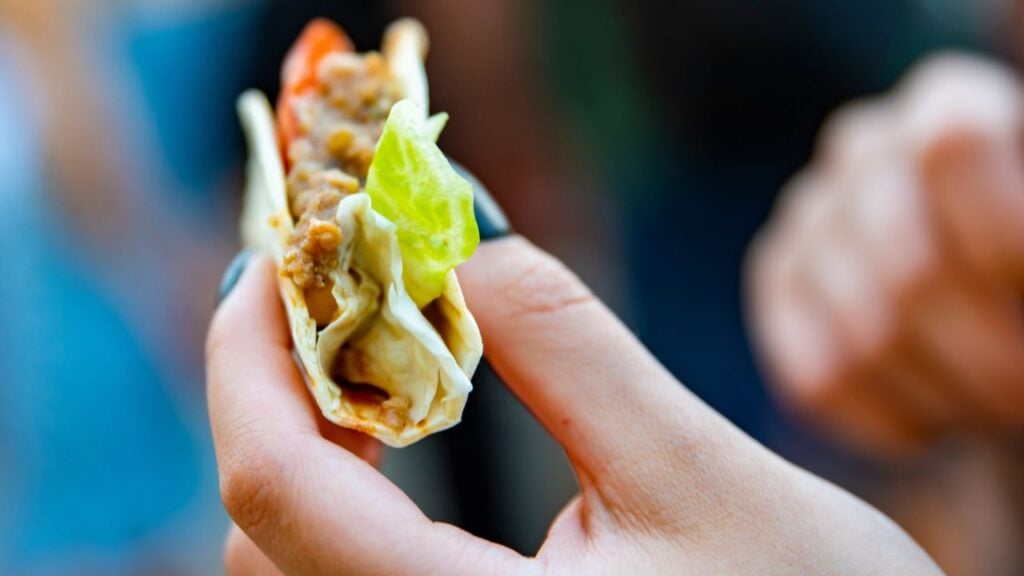 Person holding a taco.